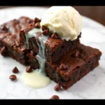 Slutty Brownie Recipe: The Ultimate Guide to Decadent Desserts 9 Decadent slutty brownies with gooey chocolate layers and vanilla ice cream on a white marble surface